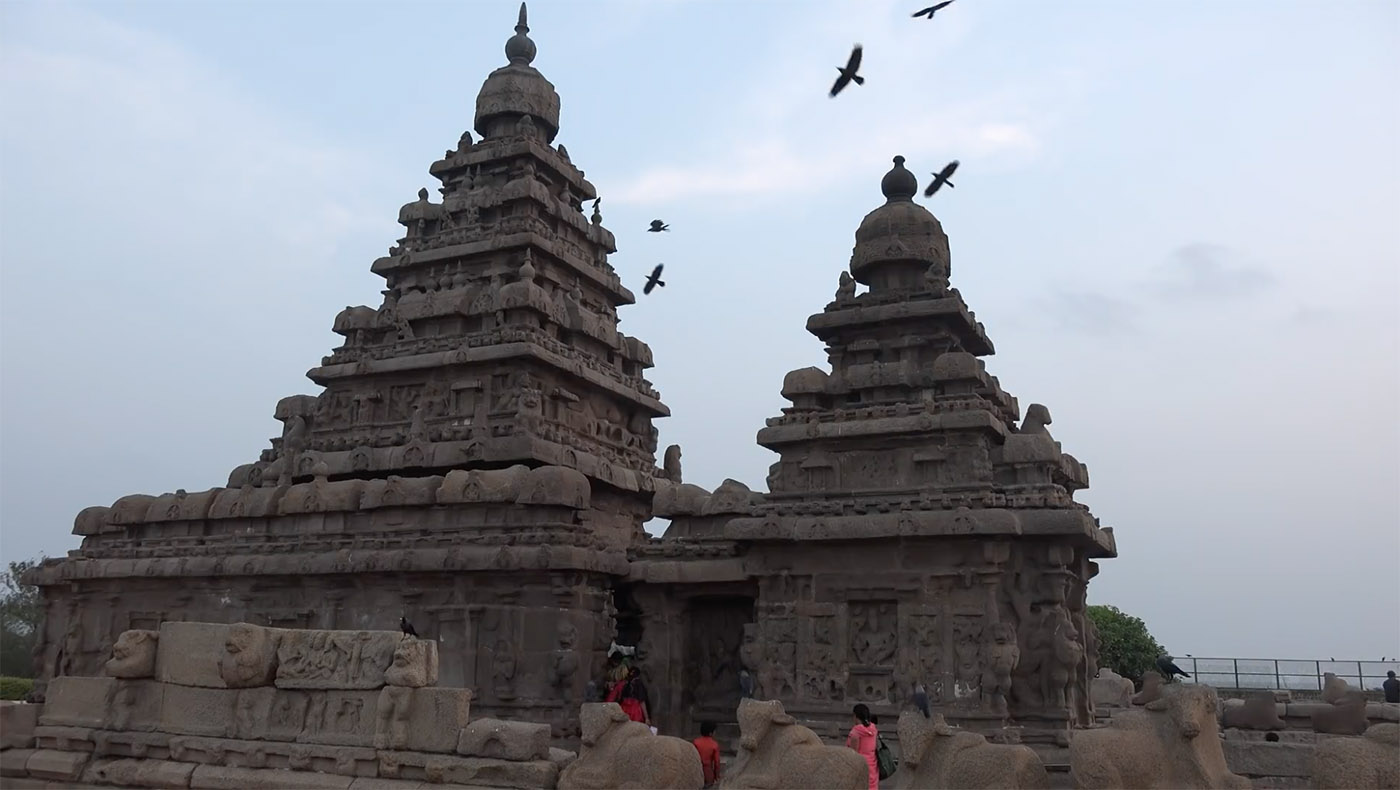 Twilight over Mahabalipuram temples, stunned by the transit of birds.